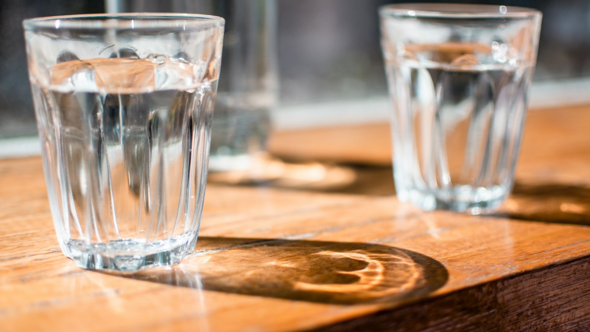 three clear drinking glass on table